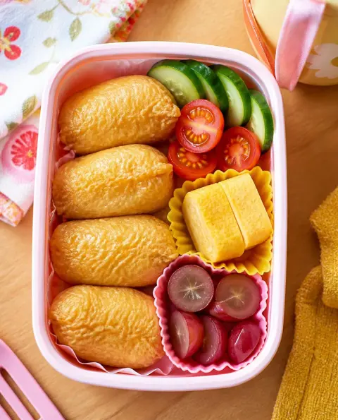 Overhead photo of Inari Sushi Pockets packed in a colourful kids' lunchbox